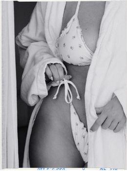 Artistic black and white photo featuring a woman in swimwear and robe, emphasizing patterns.