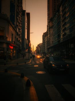 Dramatic cityscape of Buenos Aires during sunset, featuring bustling streets and modern architecture.