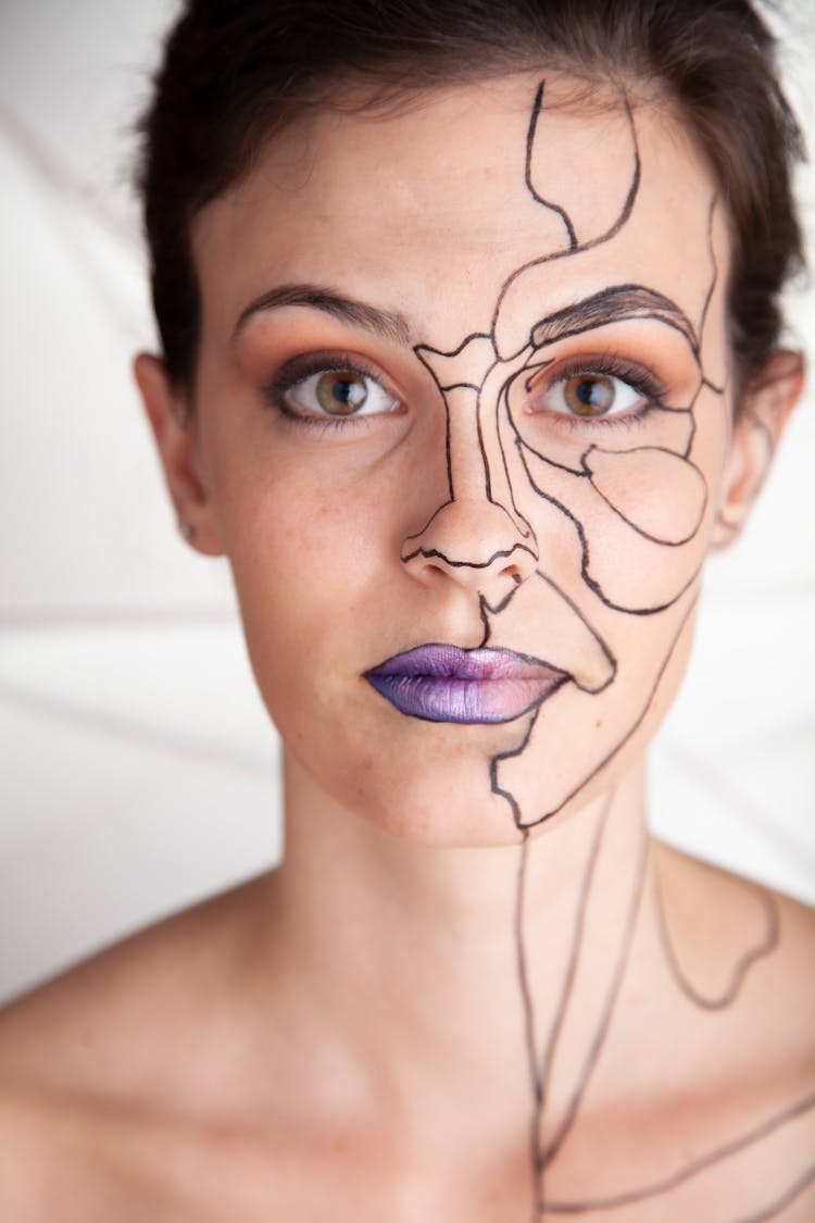 Face Of Woman With Drawings On Skin