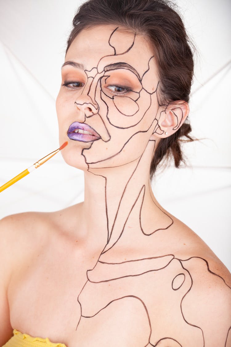 Woman With Drawing On Face And Skin