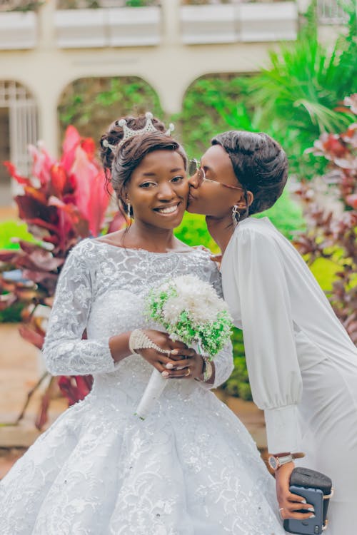 Woman Kissing the Bride on the Cheek 