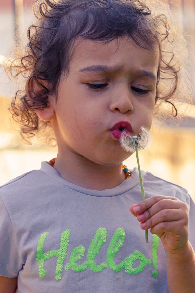 Girl Blowing Dandelion