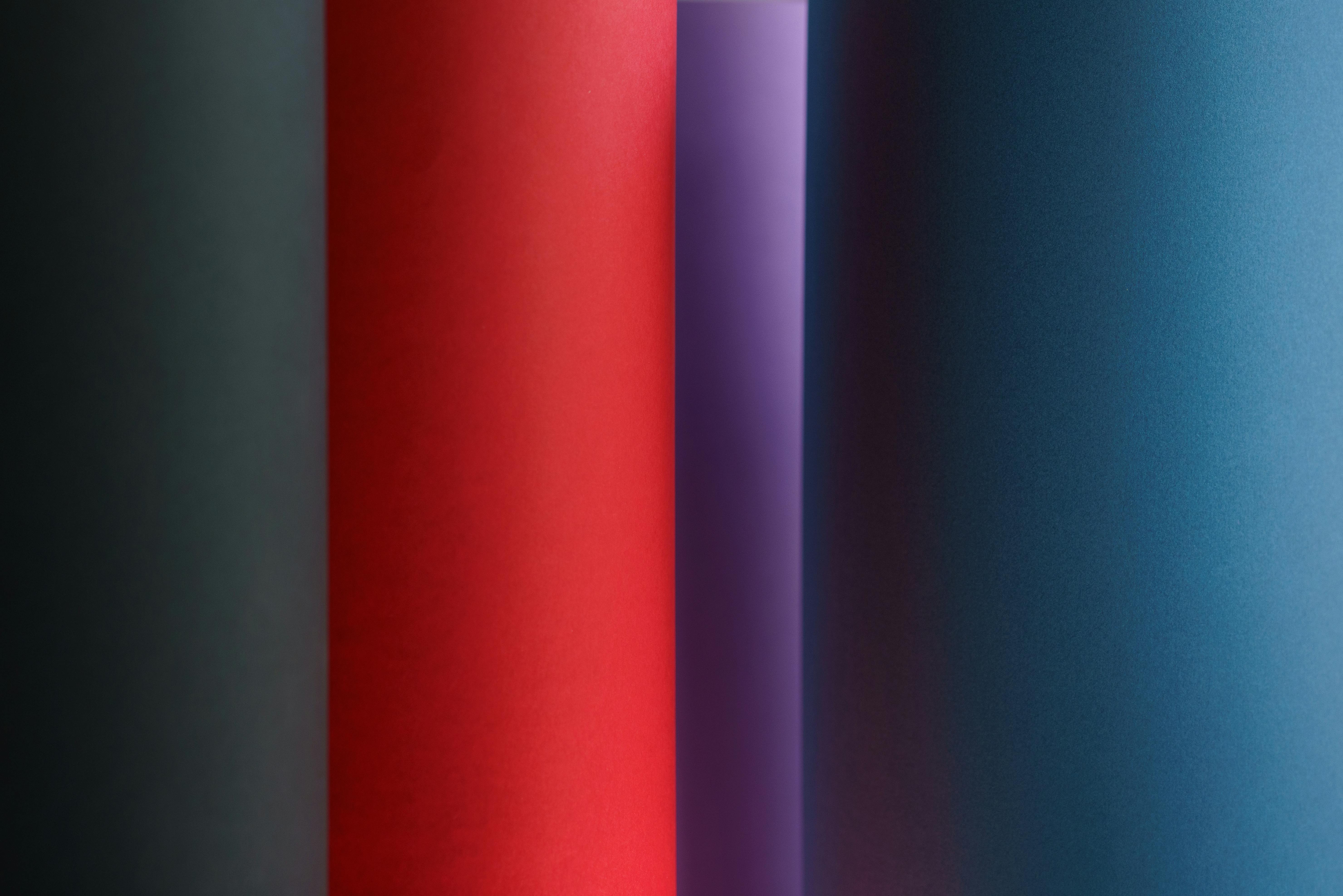 Colorful abstract background with bold red, purple, and blue gradients.