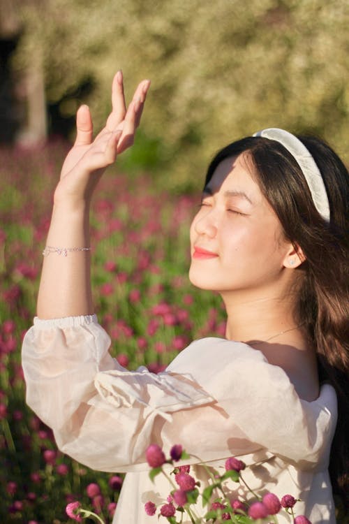 Woman Covering Face from Sunlight