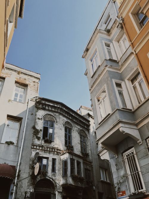 Free Explore the contrast of modern and vintage buildings in a sunlit urban alley. Stock Photo