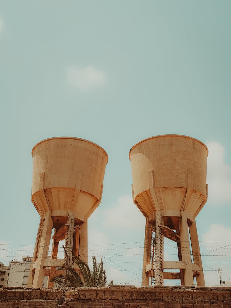 Silos Behind Barbed Wire In Town