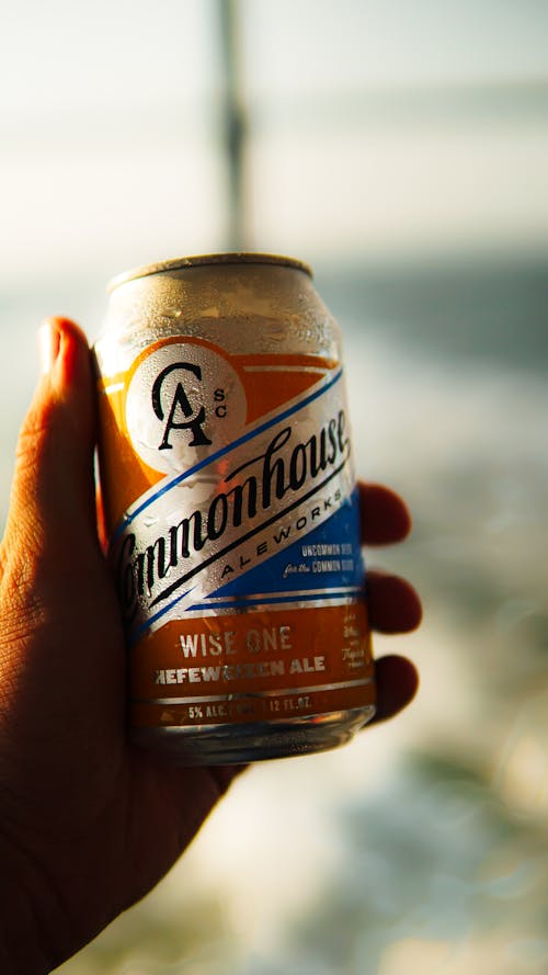 Person Holding a Can of Cold Beer 