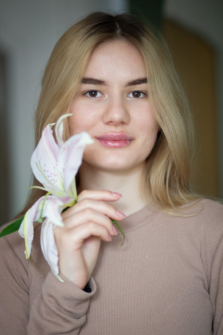 A Woman Holding A Flower