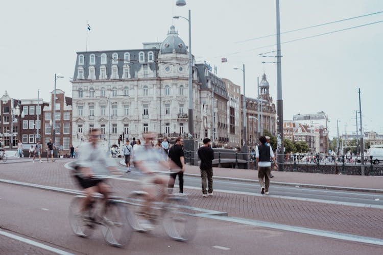 Blurred People Cycling On Street In Amsterdam