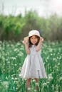 Girl Wearing Hat and Dress in Meadow