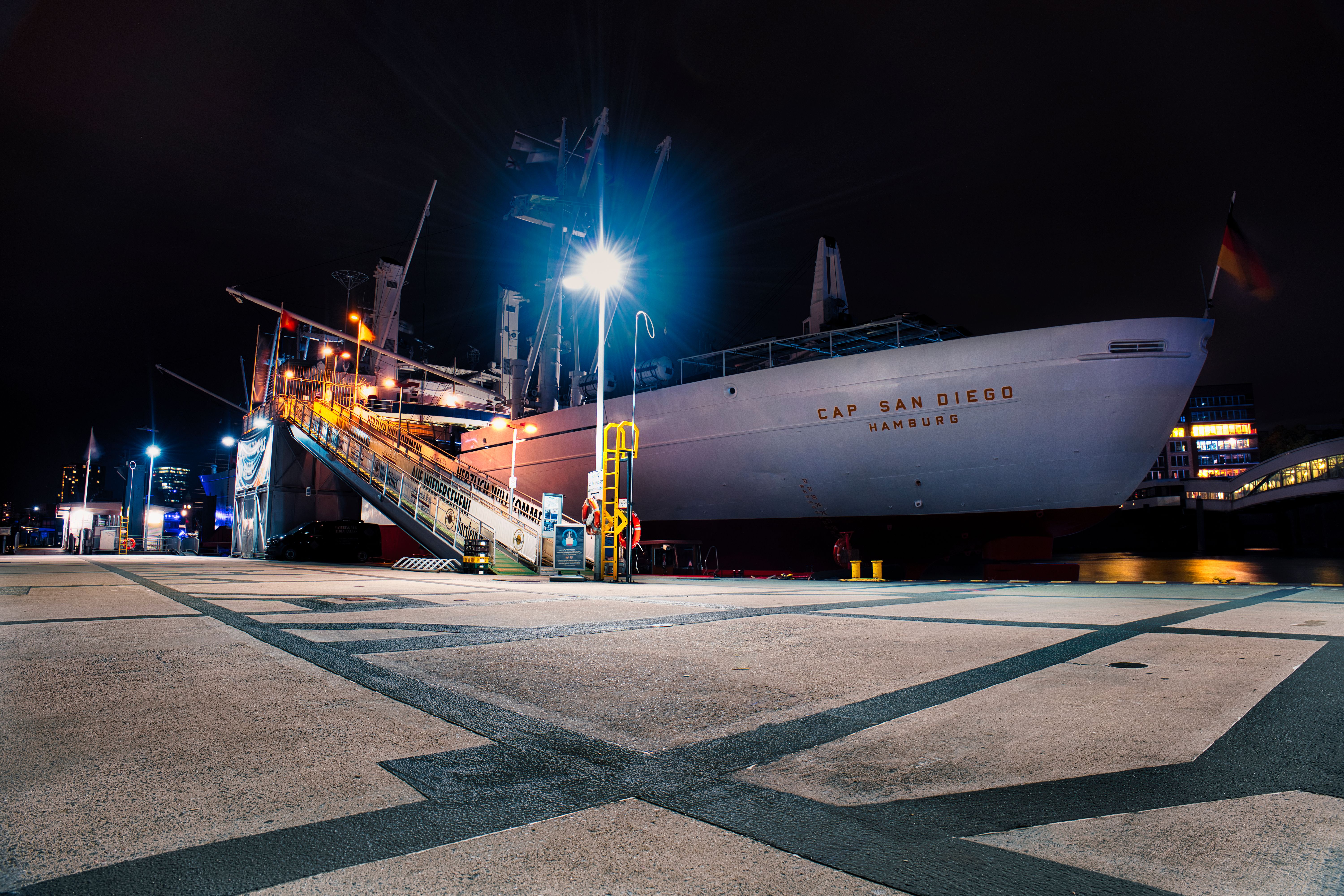 Night view of the Cap San Diego museum ship docked in Hamburg harbor.