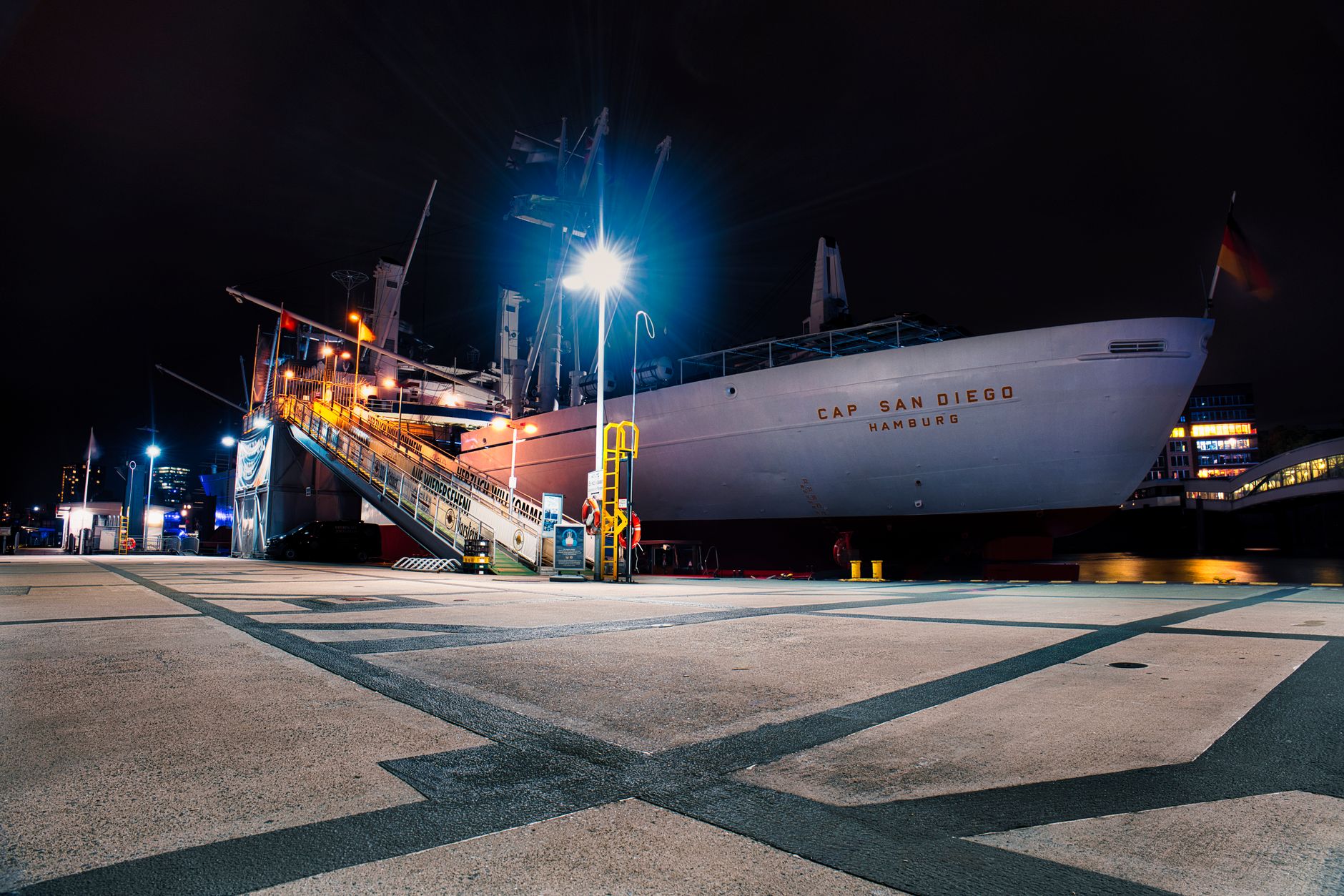 Night view of the Cap San Diego museum ship docked in Hamburg harbor.