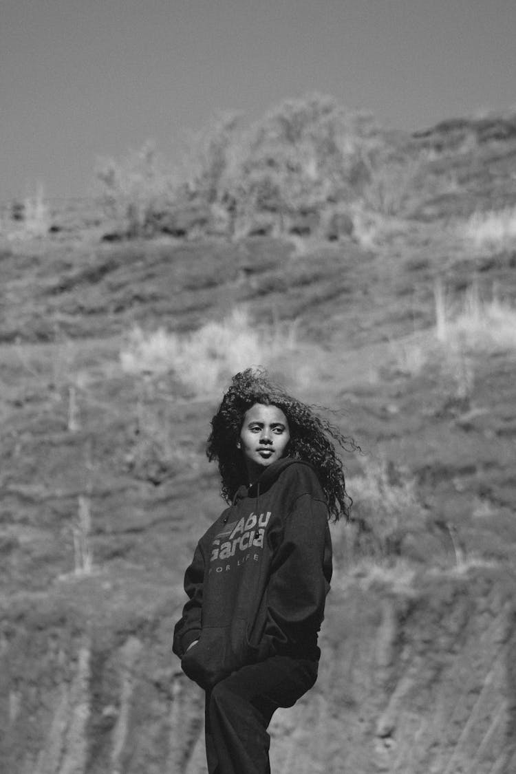 Woman Wearing Jumper Among Hills In Black And White