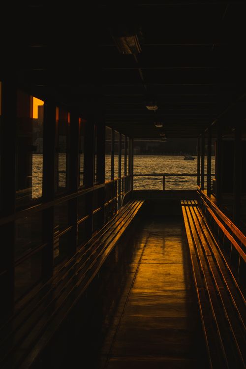 Free Sunset view from a ferry in İstanbul, showcasing warm hues and reflections on the water. Stock Photo