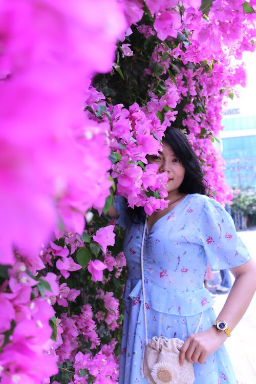 Woman Posing by Purple Flowers