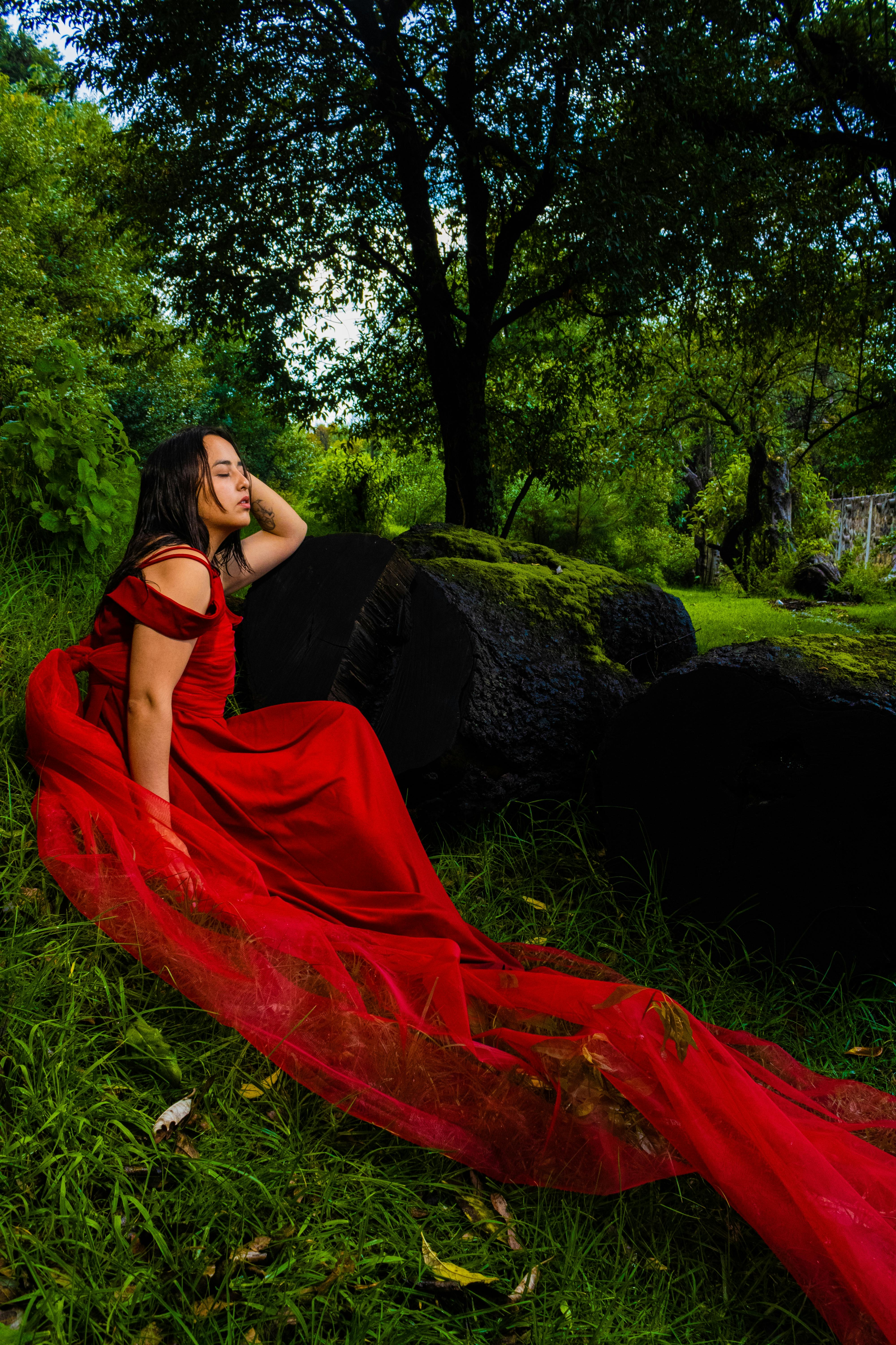 Young Woman in a Long Red Dress Posing in the Forest · Free Stock Photo