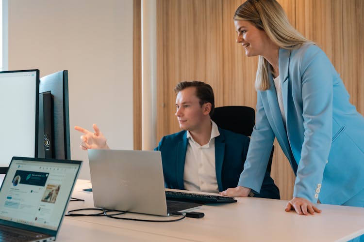 Woman And Man In Suits In Office