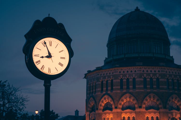 Vintage Clock In City At Night