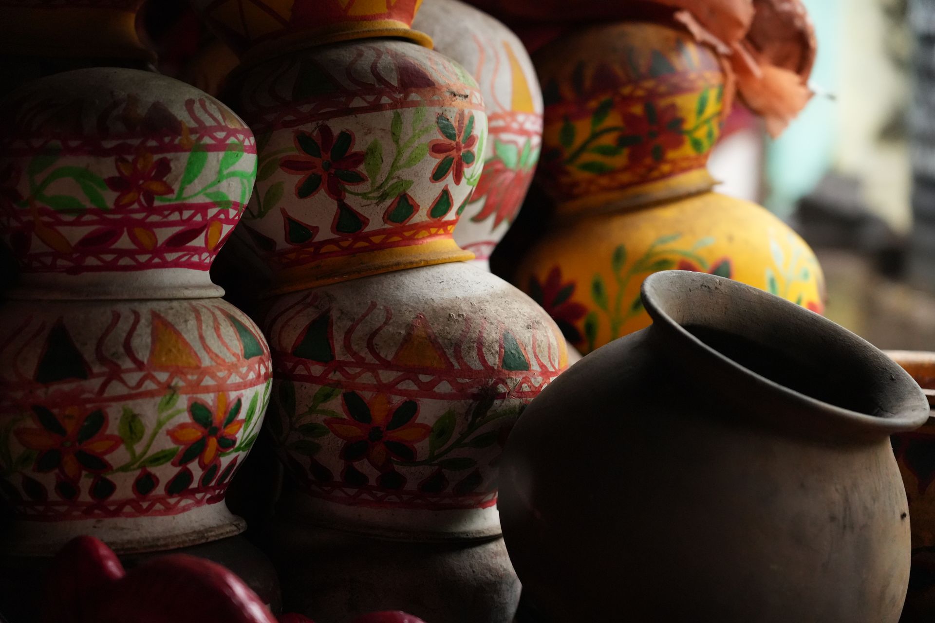 Close-up of vibrant handmade ceramic vases with traditional painted designs.