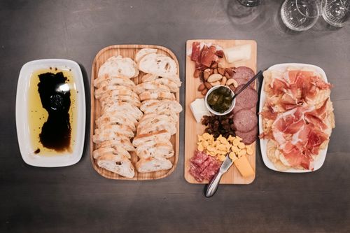 Free Top view of a gourmet charcuterie board with cured meats, cheeses, and sliced bread, perfect for gatherings. Stock Photo