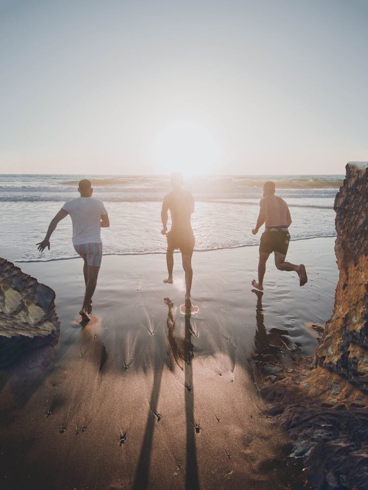 Men Running To The Beach