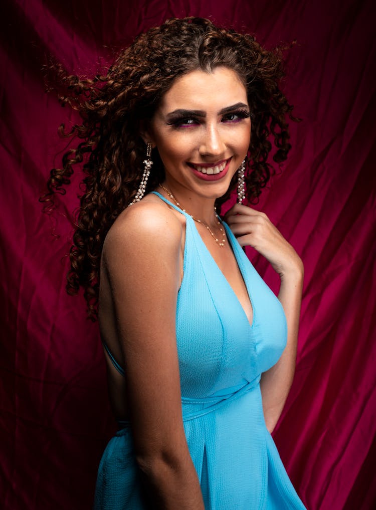 Portrait Of Smiling Woman In Blue Dress