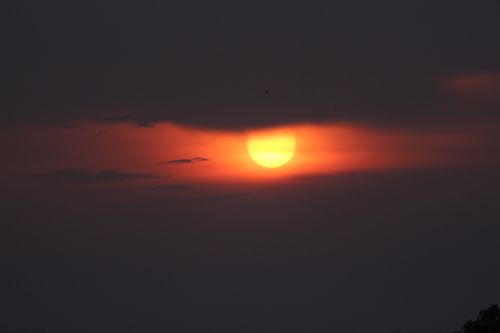Free Captivating sunset with fiery clouds casting a dramatic hue across the sky. Stock Photo