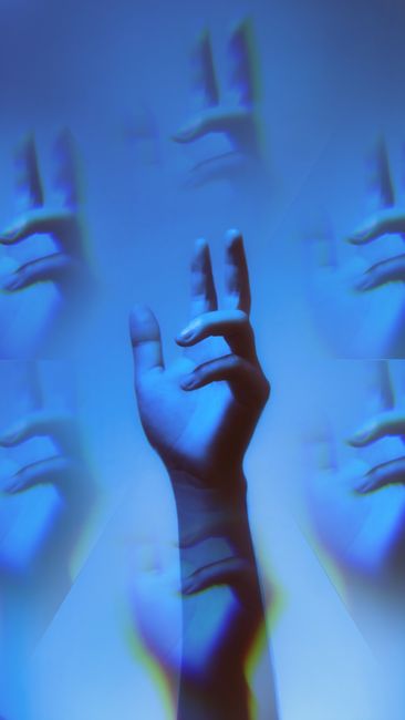 Creative abstract image of a hand in blue tones with artistic duplication effects.
