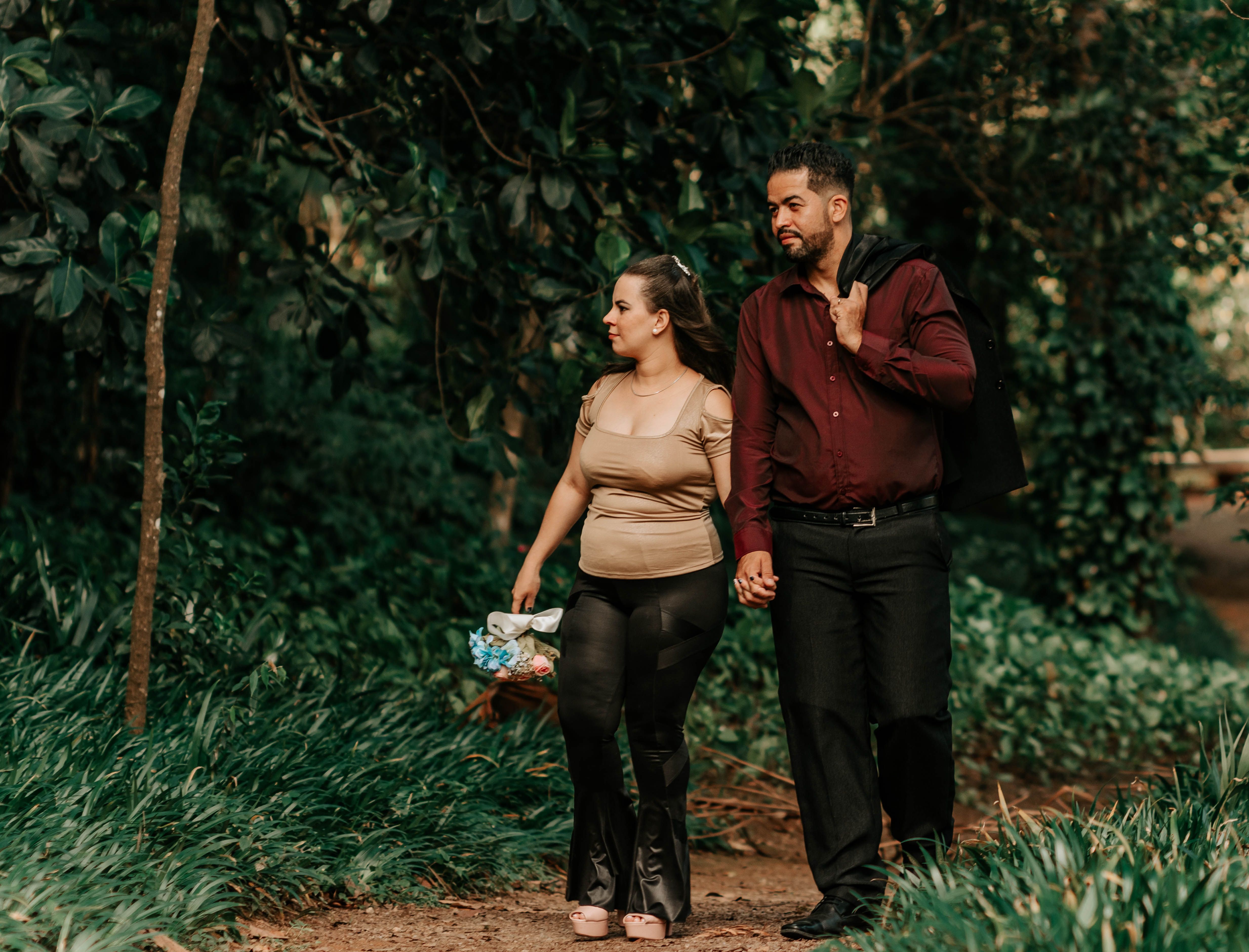A couple walking together outdoors in a peaceful wooded setting