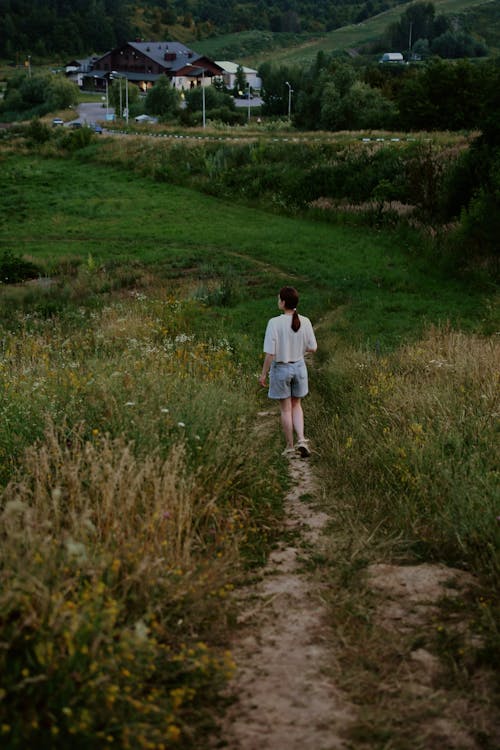 Woman Walking on Grassland in Countryside