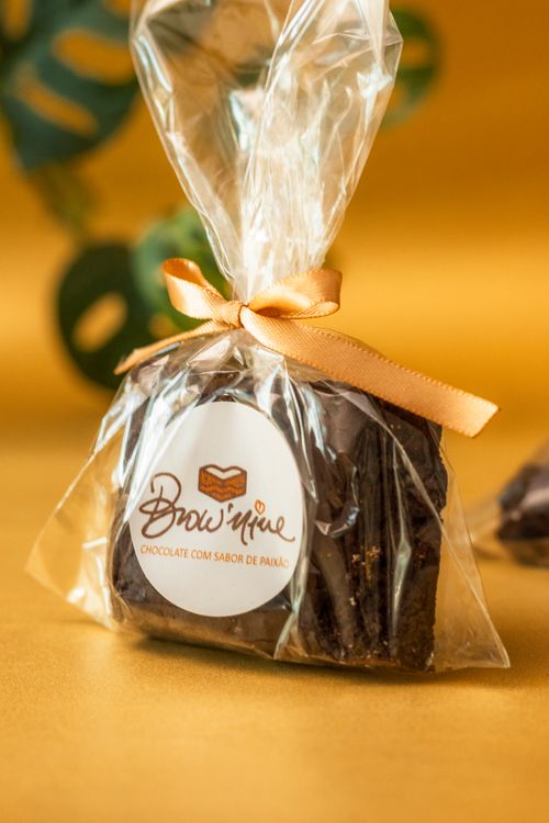 Free Delicious chocolate brownie elegantly wrapped with a golden ribbon, perfect for gifts and celebrations. Stock Photo