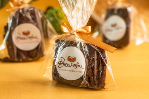 Artfully wrapped chocolate brownie with a ribbon, perfect for gifting or a sweet treat.
