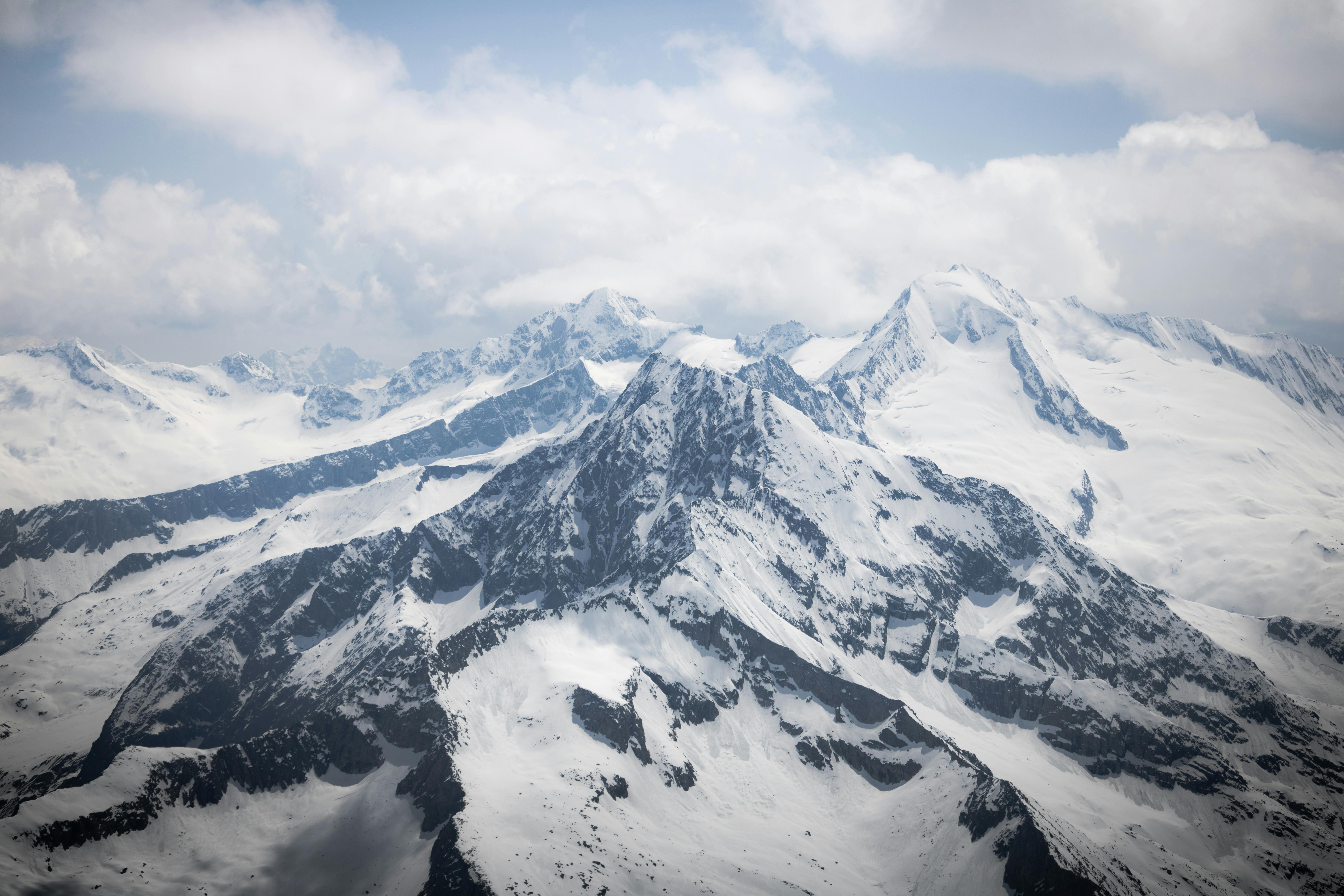 a view of a snowy mountain range from an airplane