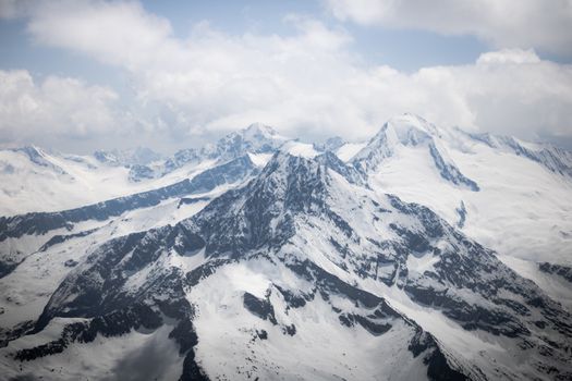 Majestic snow-covered mountains of Hintertux, Austria captured under a serene winter sky.