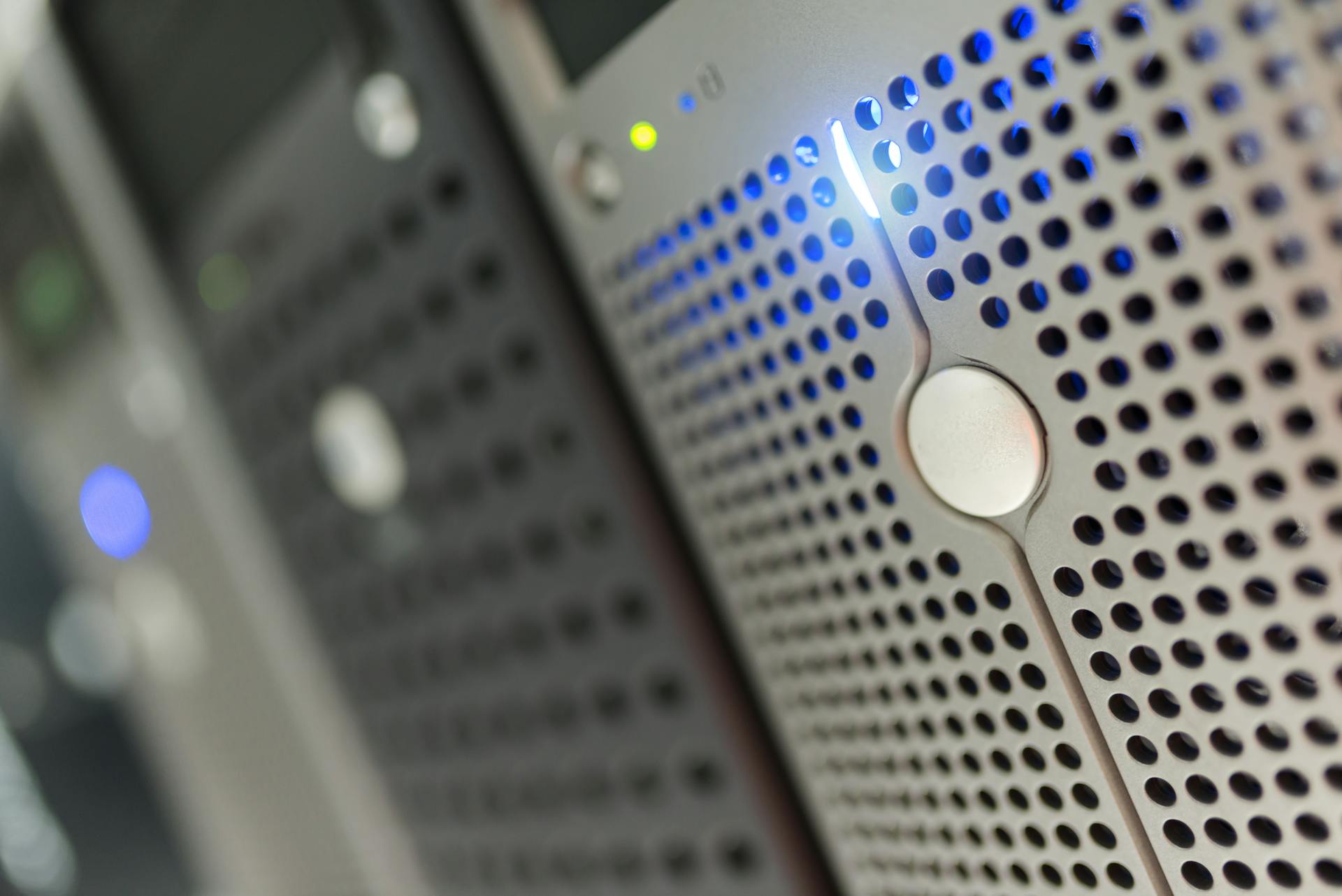 Focused detail of a modern server rack with blue LED indicators in a data center.