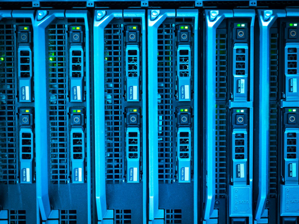 Server rack illuminated in blue inside a data centre