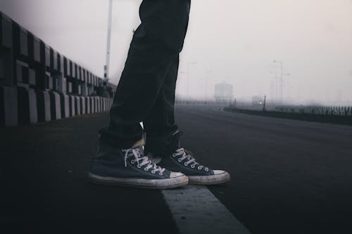 Free Person In Blue Sneakers Standing On Road Stock Photo
