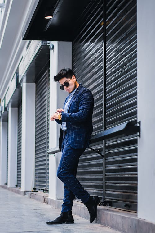 Young Elegant Man in a Suit Posing on the Sidewalk 
