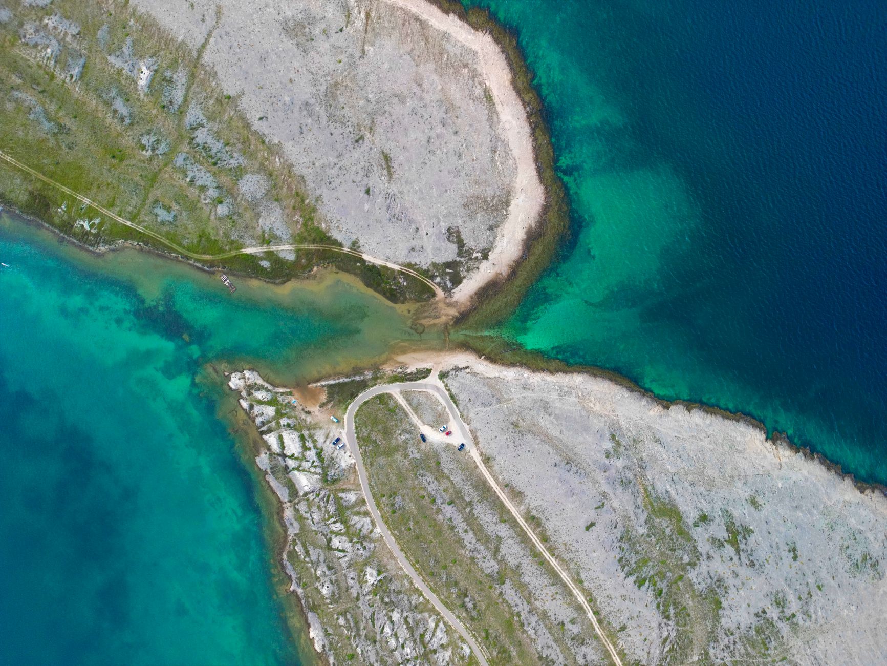 Explore the stunning turquoise waters and rocky coastlines of Vrsi, Croatia from above.