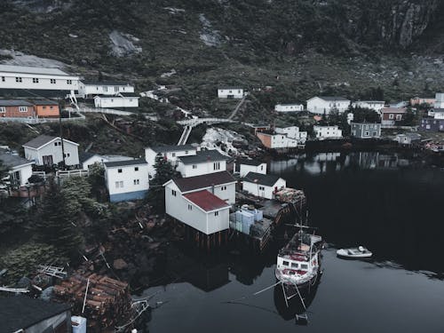 Boat Docked on Lake Shore by Village