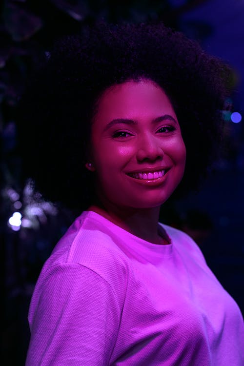 Smiling Woman in Pink Light