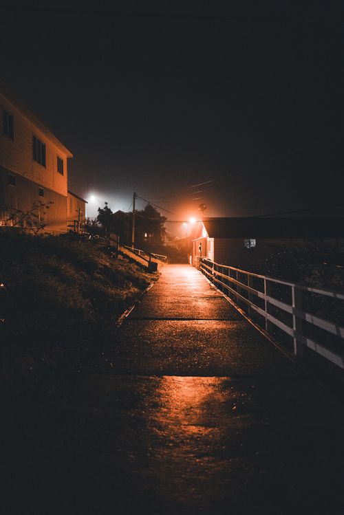 Free A dimly lit street with glowing orange lights, creating a moody atmosphere. Stock Photo