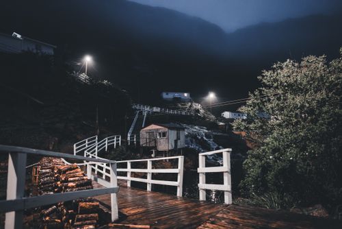 Free Explore a serene fishing village under the mystical night sky. Stock Photo