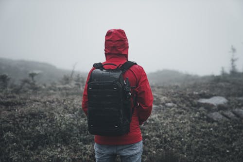 Back of a Hiker Wearing a Red Hooded Jacket