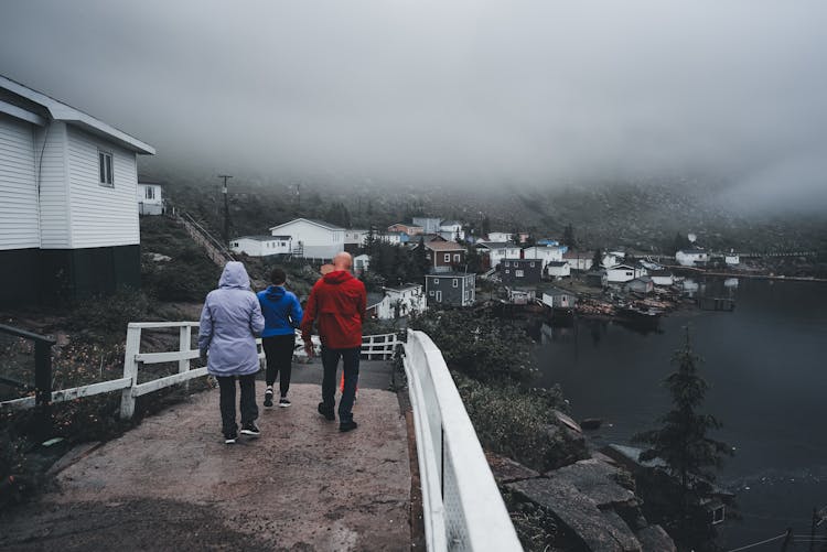 People Walking In Village On Shore