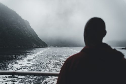 Silhouette of Man Sailing on Sea Coast