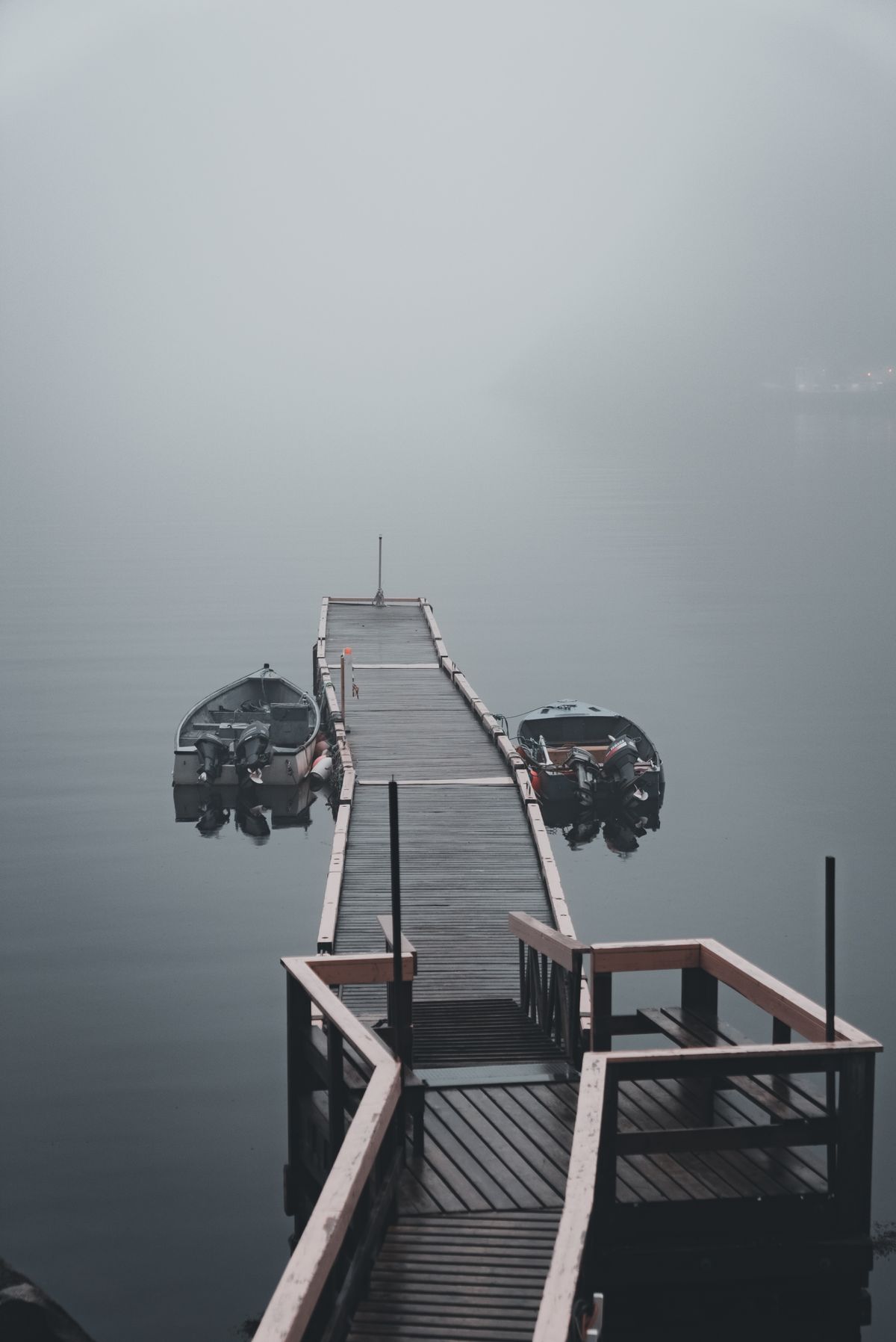 Private wooden boat dock on serene inland lake water