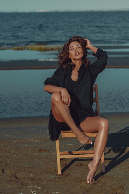 Woman Posing on Chair on Beach