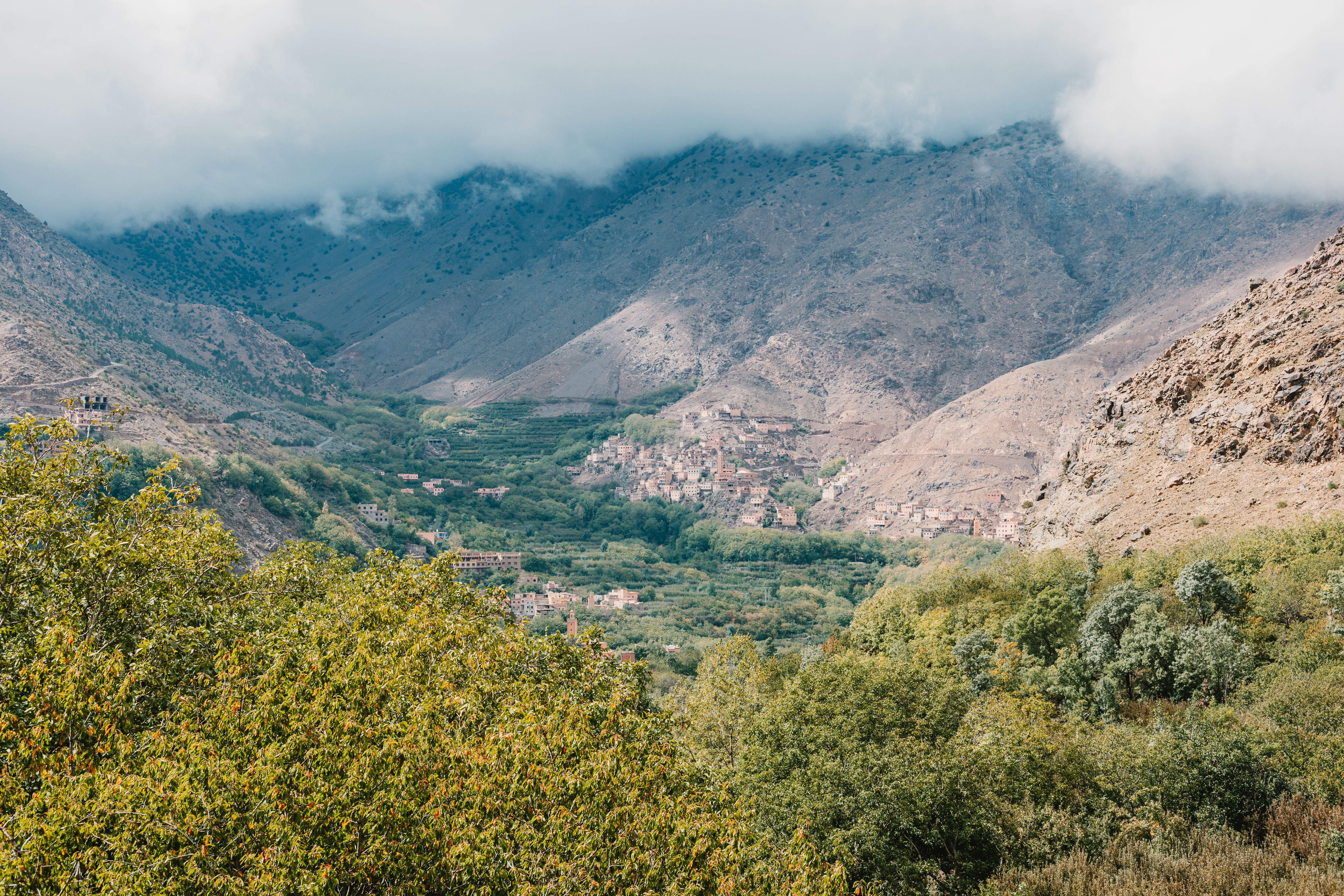 Scenic aerial view of Toubkal Valley in Morocco with lush greenery and mountains.