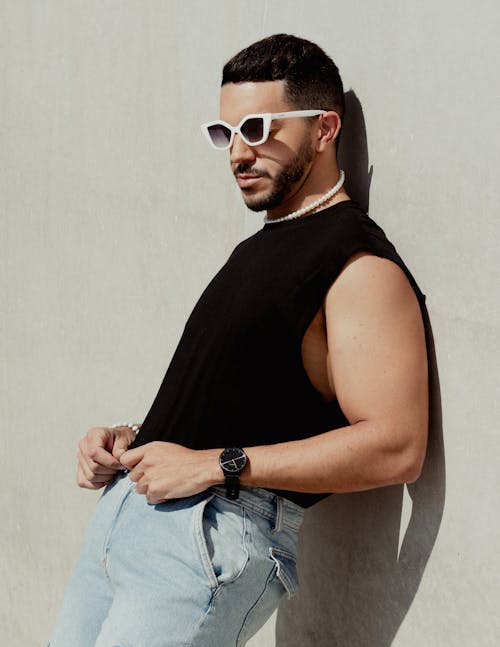 Man in Tank Top Leaning by Wall